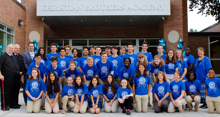 best private high schools near syracuse ny image of student group photo wearing matching blue shirts in front of christian brothers academy
