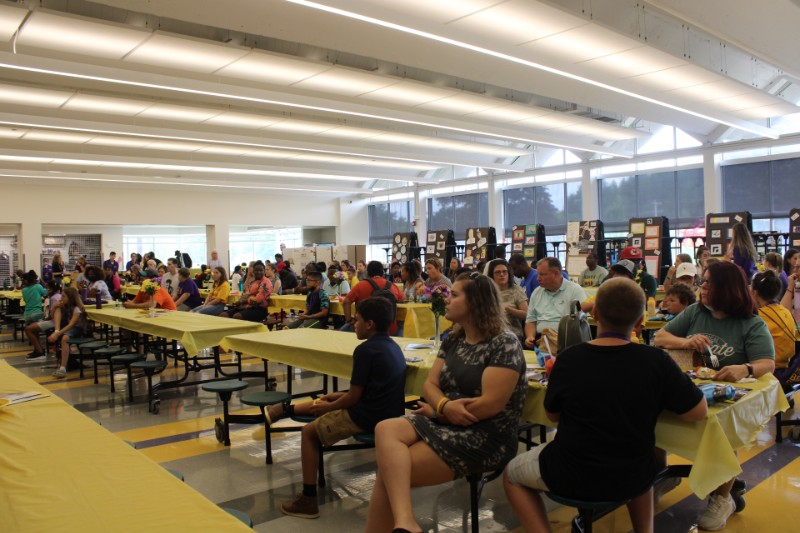 Bridge To CBA Brothers Participants Recognized At Reception near syracuse ny image of students in cafeteria