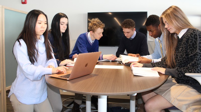 private high schools near syracuse ny image of four students sitting in library with books