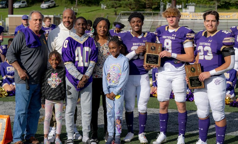 Alumni Association Hosts Homecoming Tailgate near syracuse ny image of family holding awards