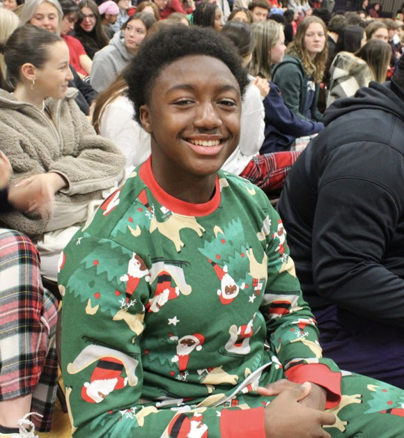 merry christmas image of smiling student in christmas pajamas