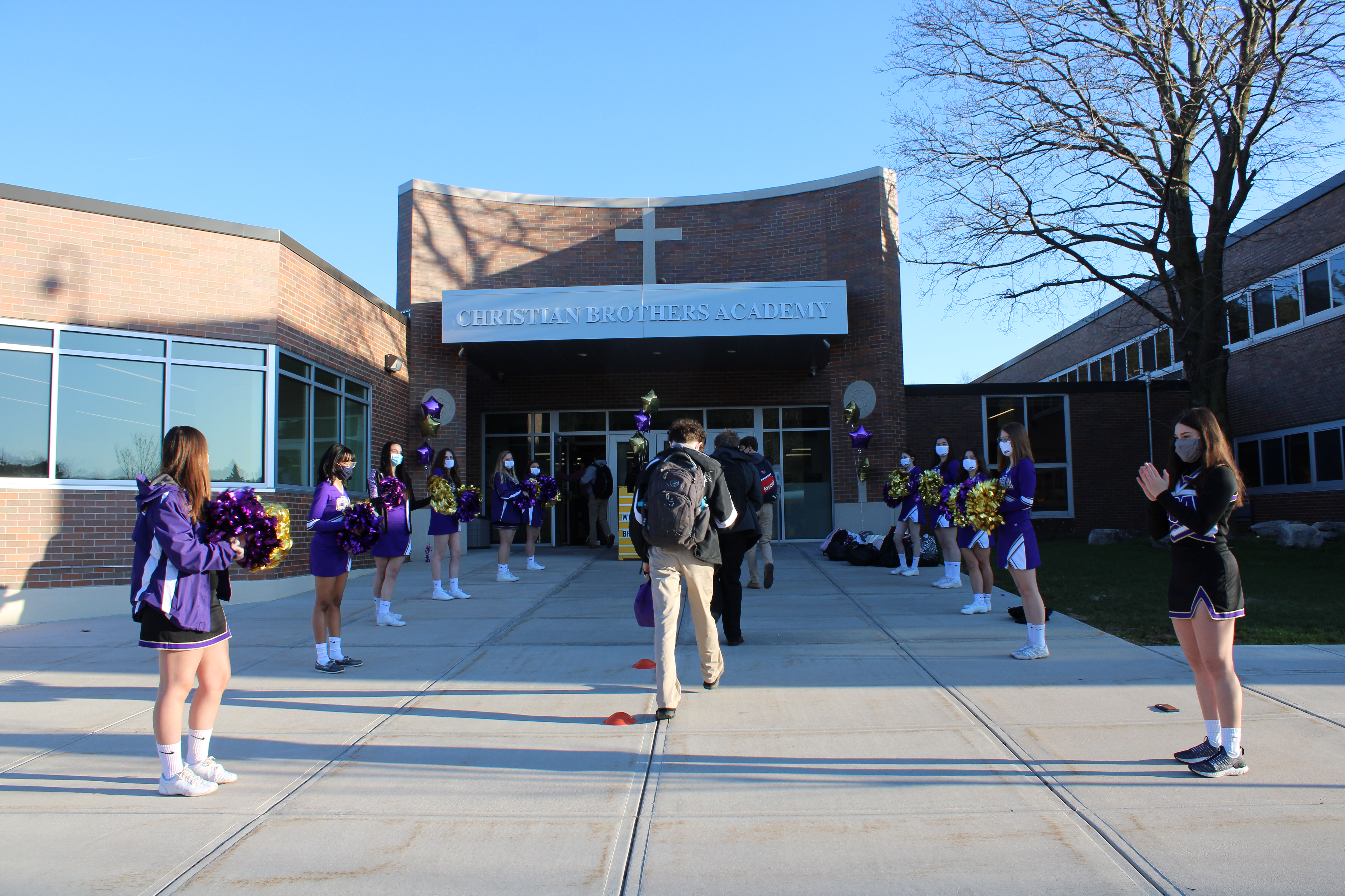 CBA Students Return To Five Day In-Person Learning near syracuse ny image of cheerleaders leading students to cba