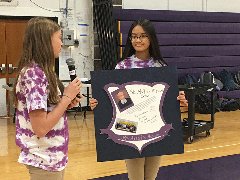 students with house crests poster image of two students one with microphone and other with house crest