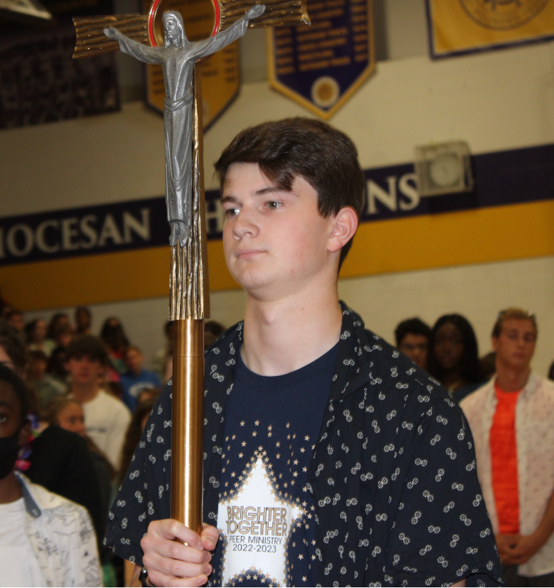 School Celebrates Mass of The Holy Spirit near syracuse ny image of student holding cross