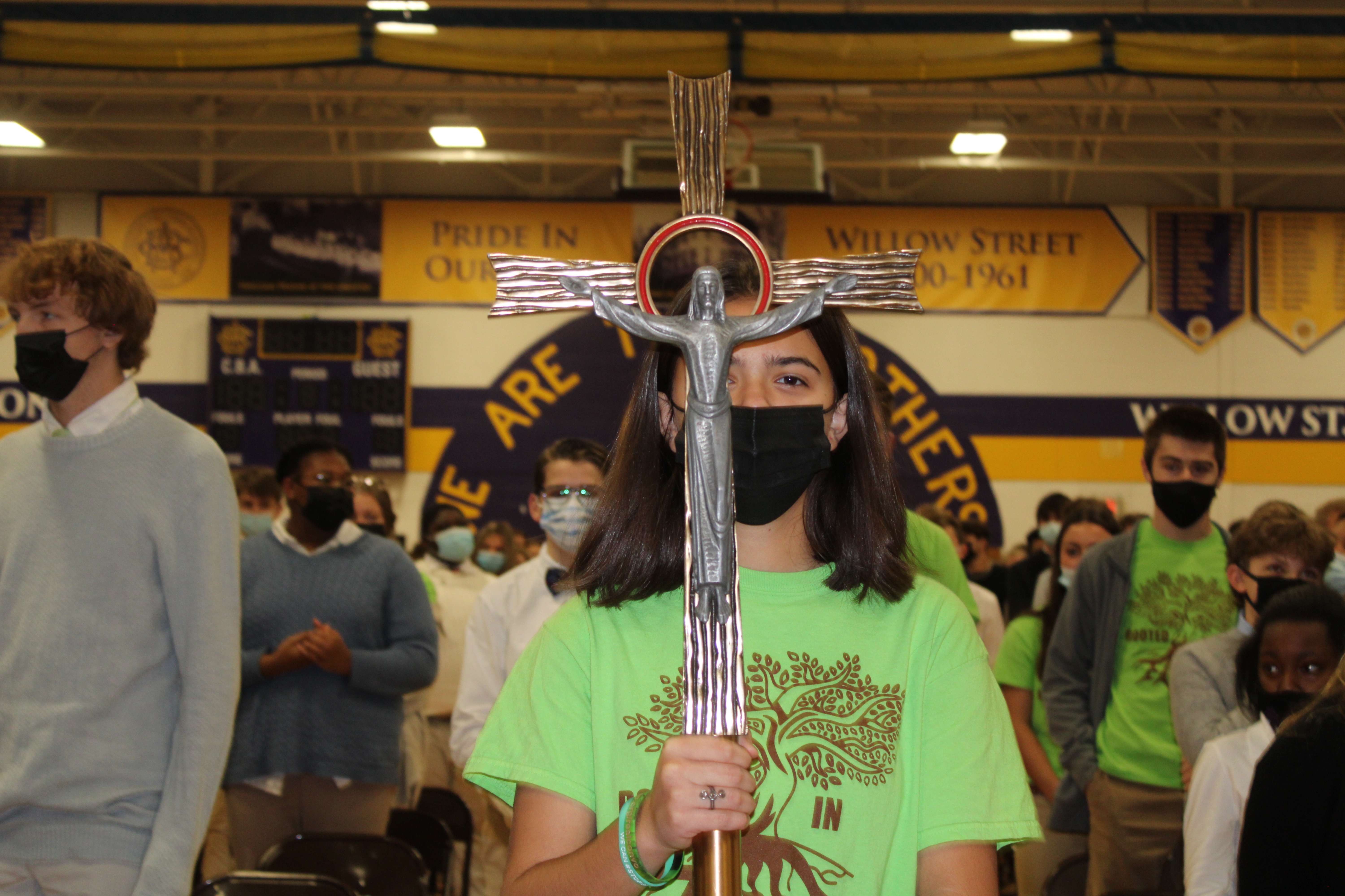 CBA Community Celebrates All Saints Mass On Nov. 1 near syracuse ny image of student holding cross