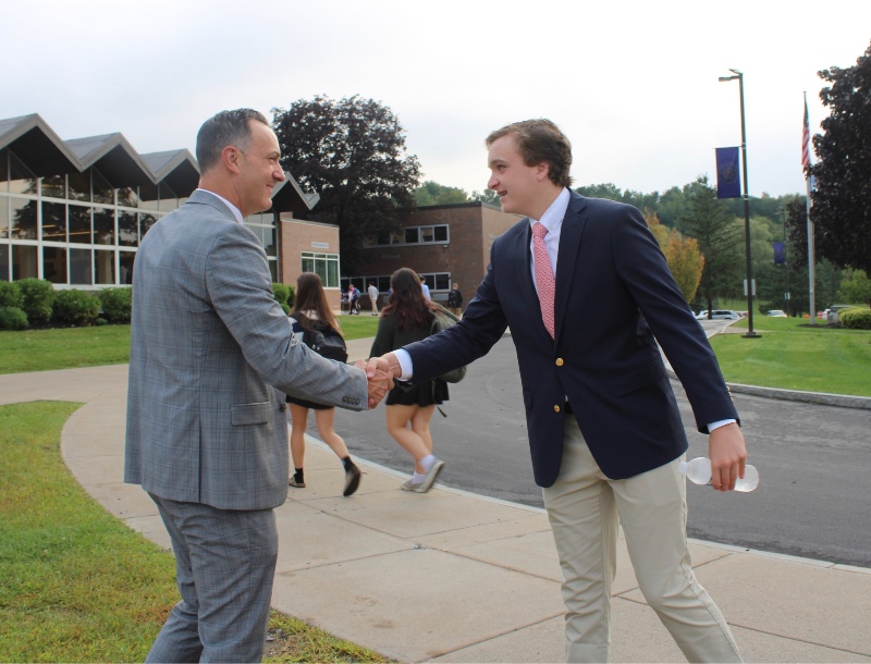 welcome back cba students image of bruce williams shaking hands with man at cba