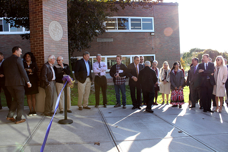 cba ribbon cutting ceremony group of people standing around ribbon