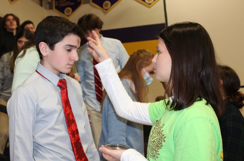 CBA Community Celebrates Ash Wednesday near syracuse ny image of students helping with ash wednesday