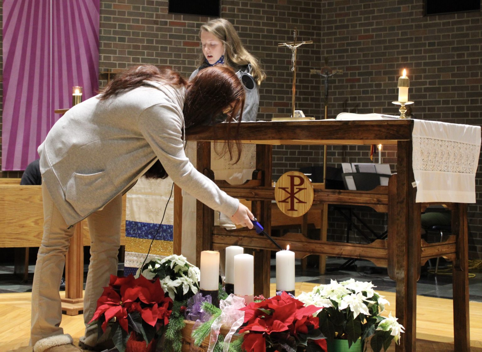CBA Celebrates The Feast Of The Immaculate Conception near syracuse ny image of students lighting candles