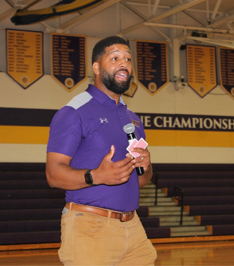 welcome back cba students image of gym coach giving speech at orientation at cba