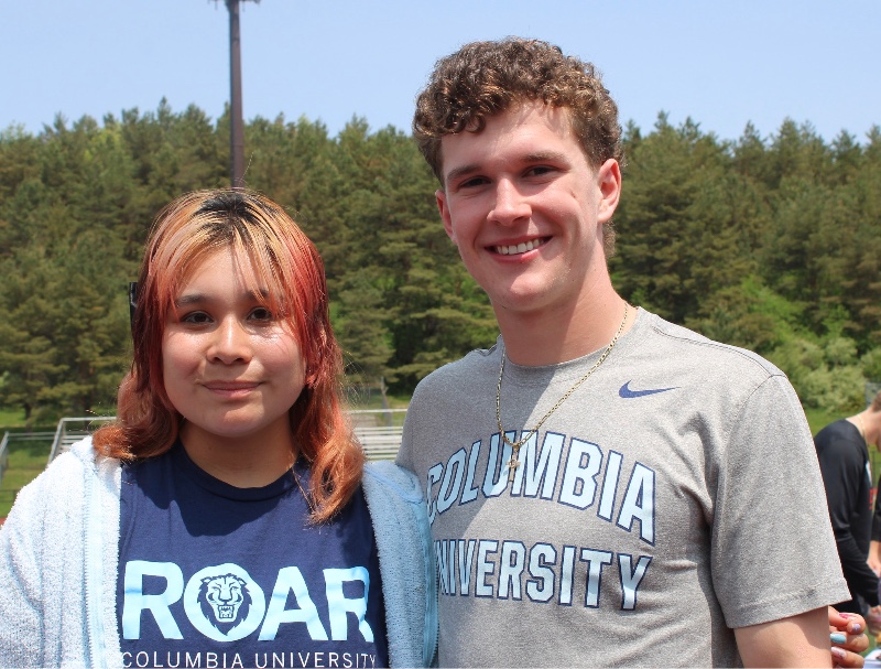 college bound class of 2023 image of two students from cba with college acceptance shirts on