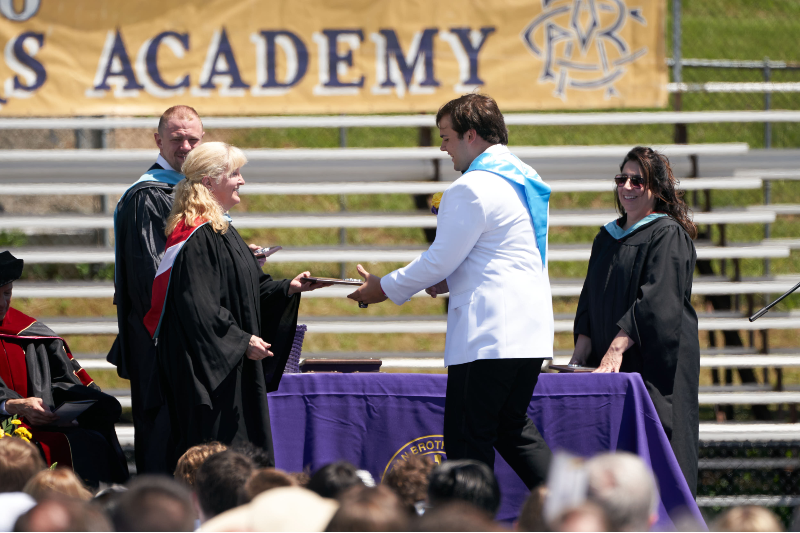 126 Students Graduate From Christian Brothers Academy near syracuse ny image of student shaking hand with teacher