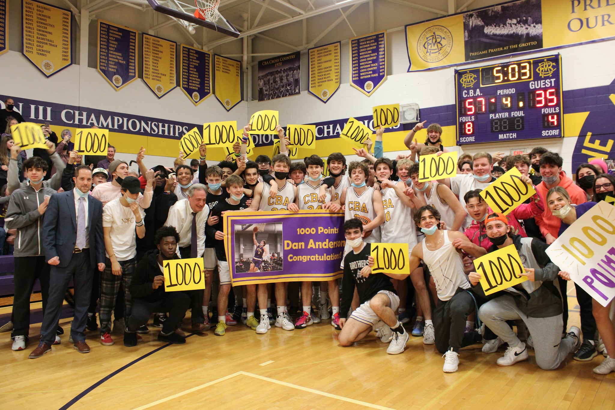 Anderson Scores 1,000 Career Point near syracuse ny image of basketball team smiling